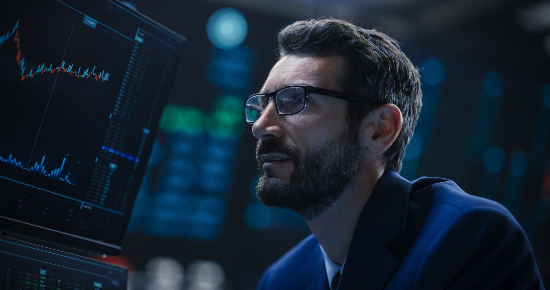 Portrait of a Handsome Bearded Stock Market Trader Working in a Stock Exchange Company. Adult Man Wearing Glasses, Researching Investment Possibilities for International Business Corporations